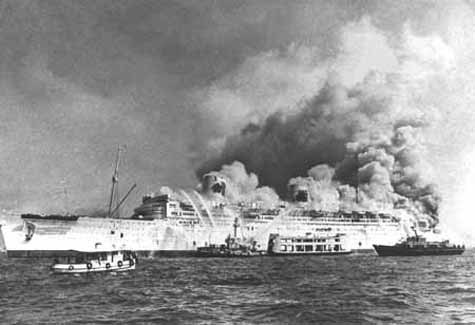 The RMS Queen Elizabeth on fire in Hong Kong harbour in January 1972.