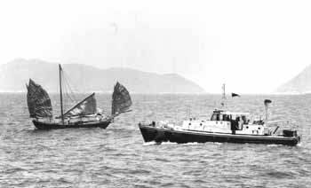 70ft patrol vessel checking sailing junk off the south coast of Hong Kong Island in the 1960s.