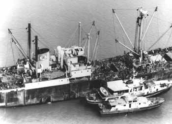 Refugee ship Skyluck in February 1979 with police vessels alongside.