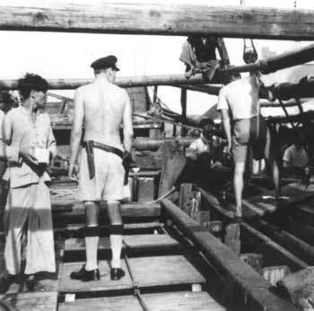 Marine police inspector on armed Chinese junk in the early 1950s.